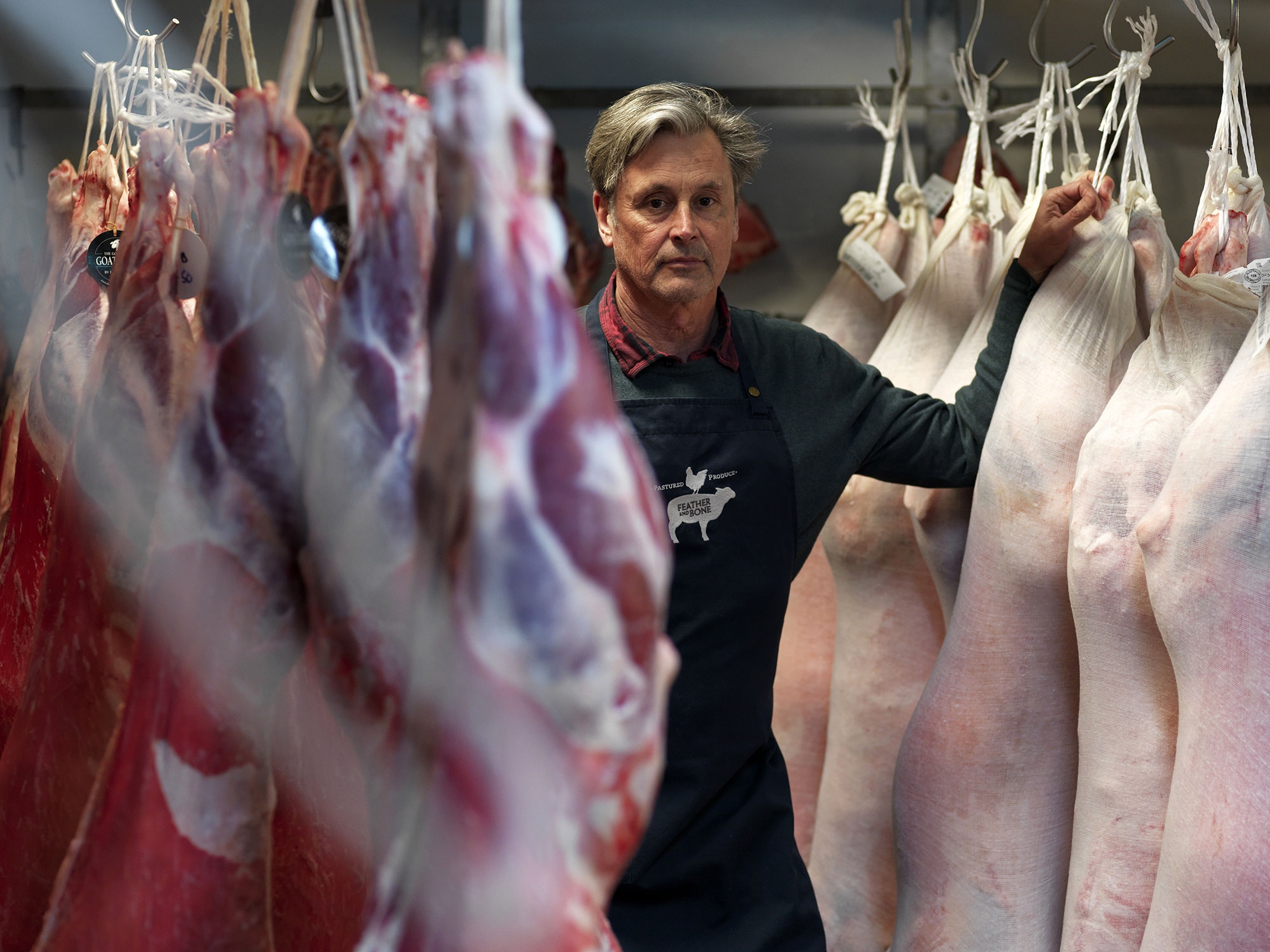 Grant Hilliard amongst goat and lamb whole carcases at Feather and Bone.