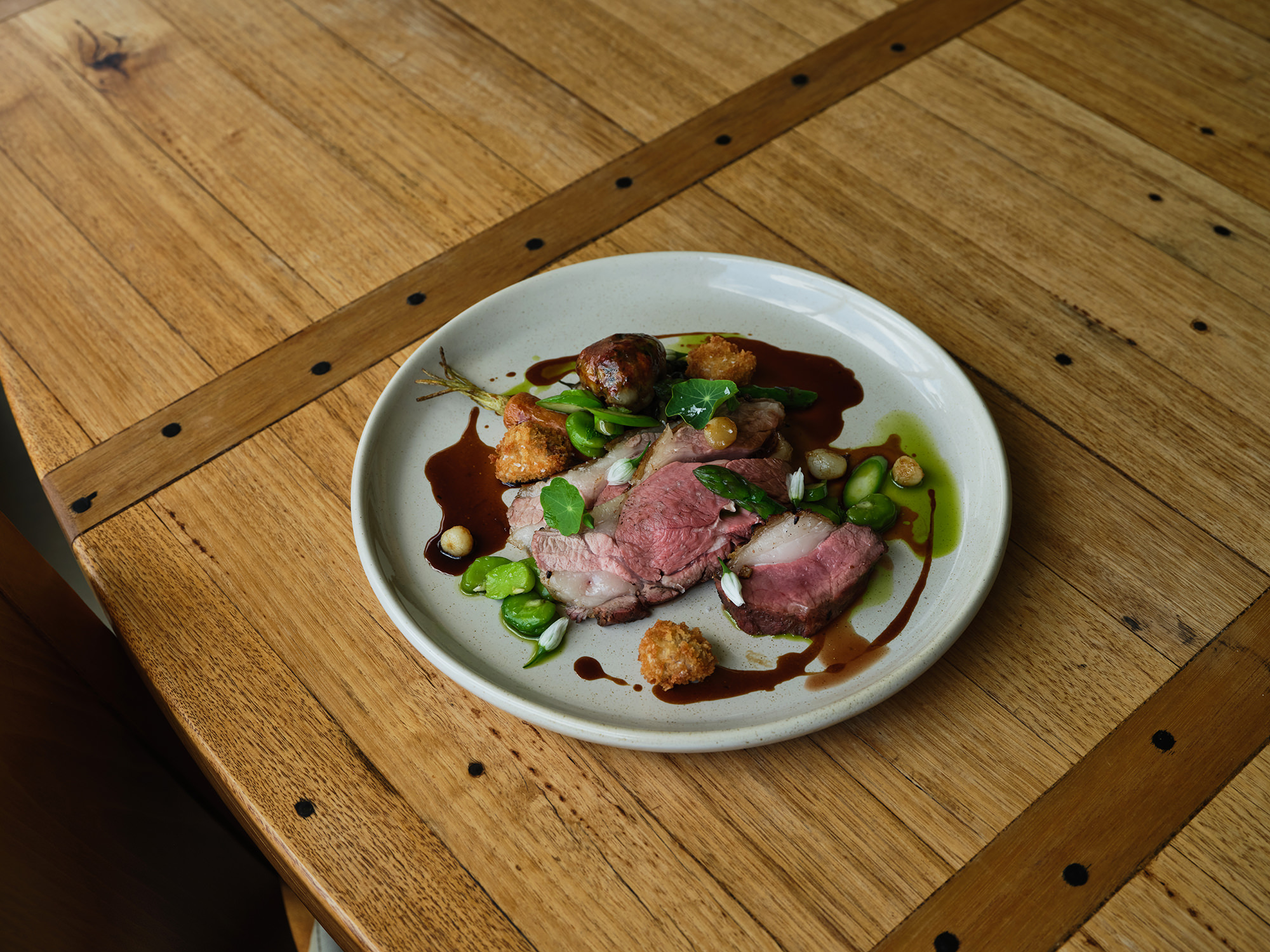A ‘Gippsland Lamb’ dish featuring rump, backstrap, a lamb crepinette of leg, kidney and liver, and crumbed brain.