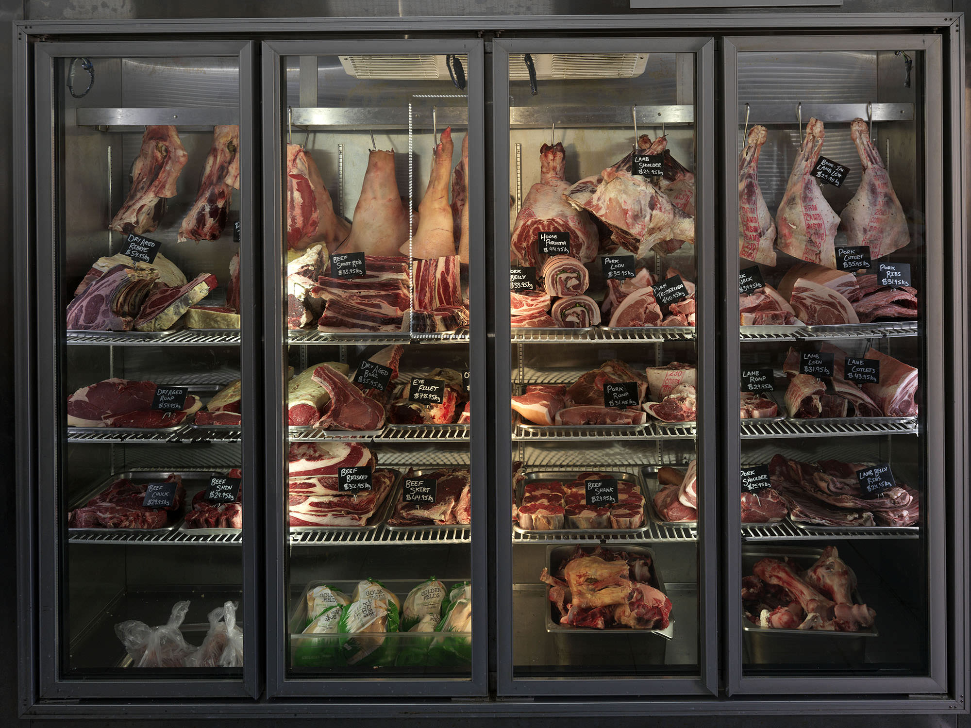 Fridges stocked with nose to tail dry aged produce at Whole Beast Butchery.