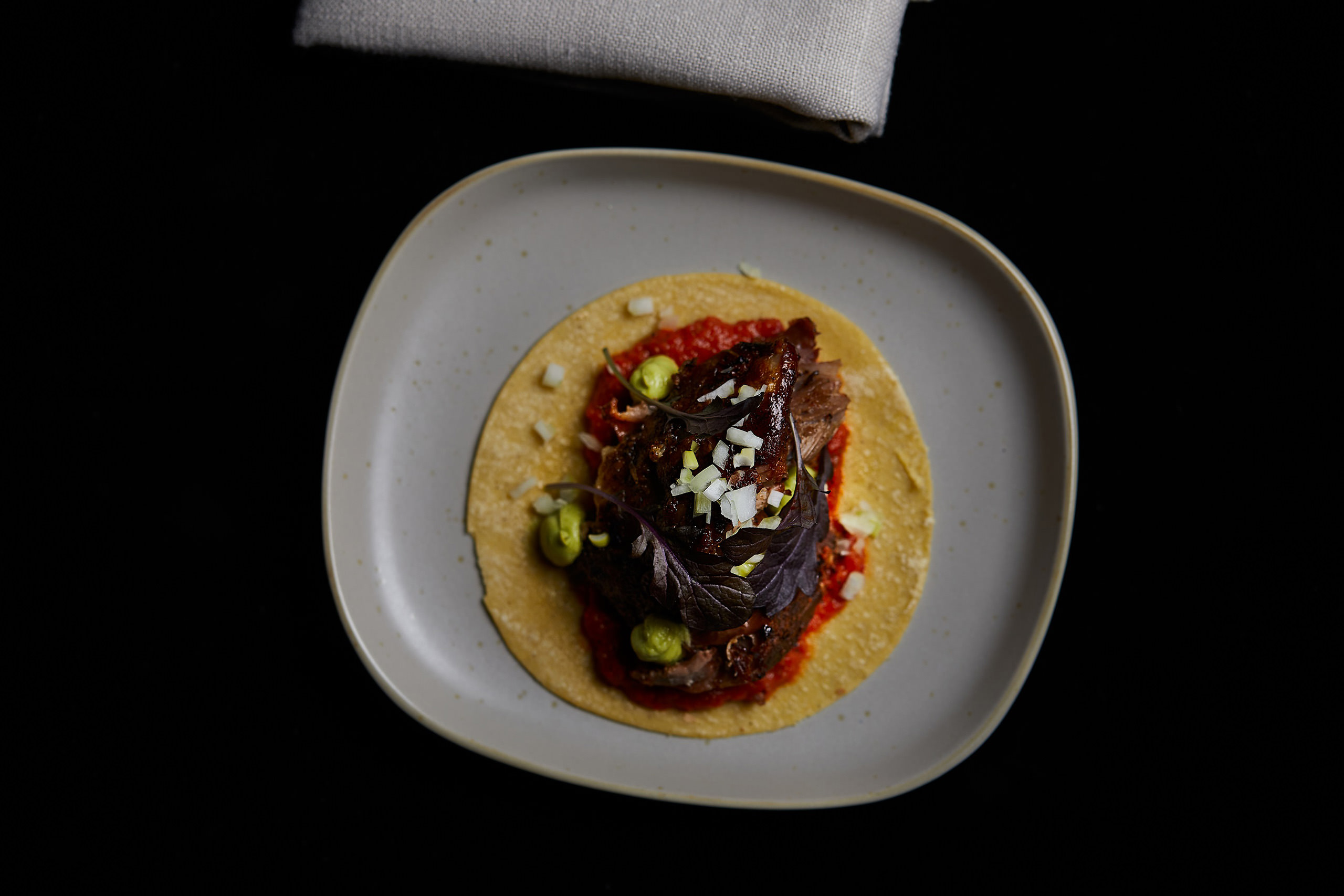 Esteban’s lamb shoulder with smoked salsa roja, white onion, avocado and cactus puree.