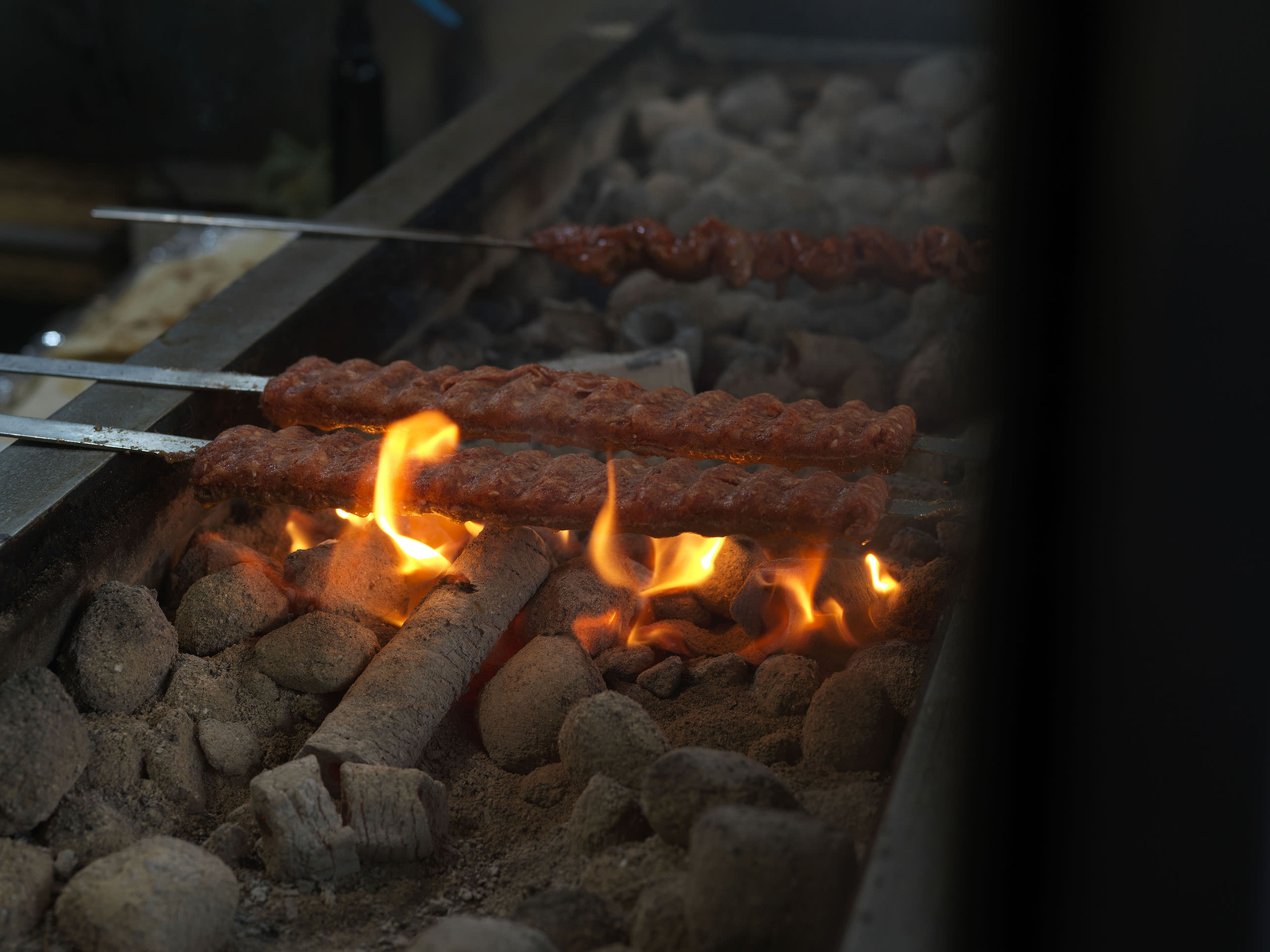 Meat cooked over coals at New Star Kebab