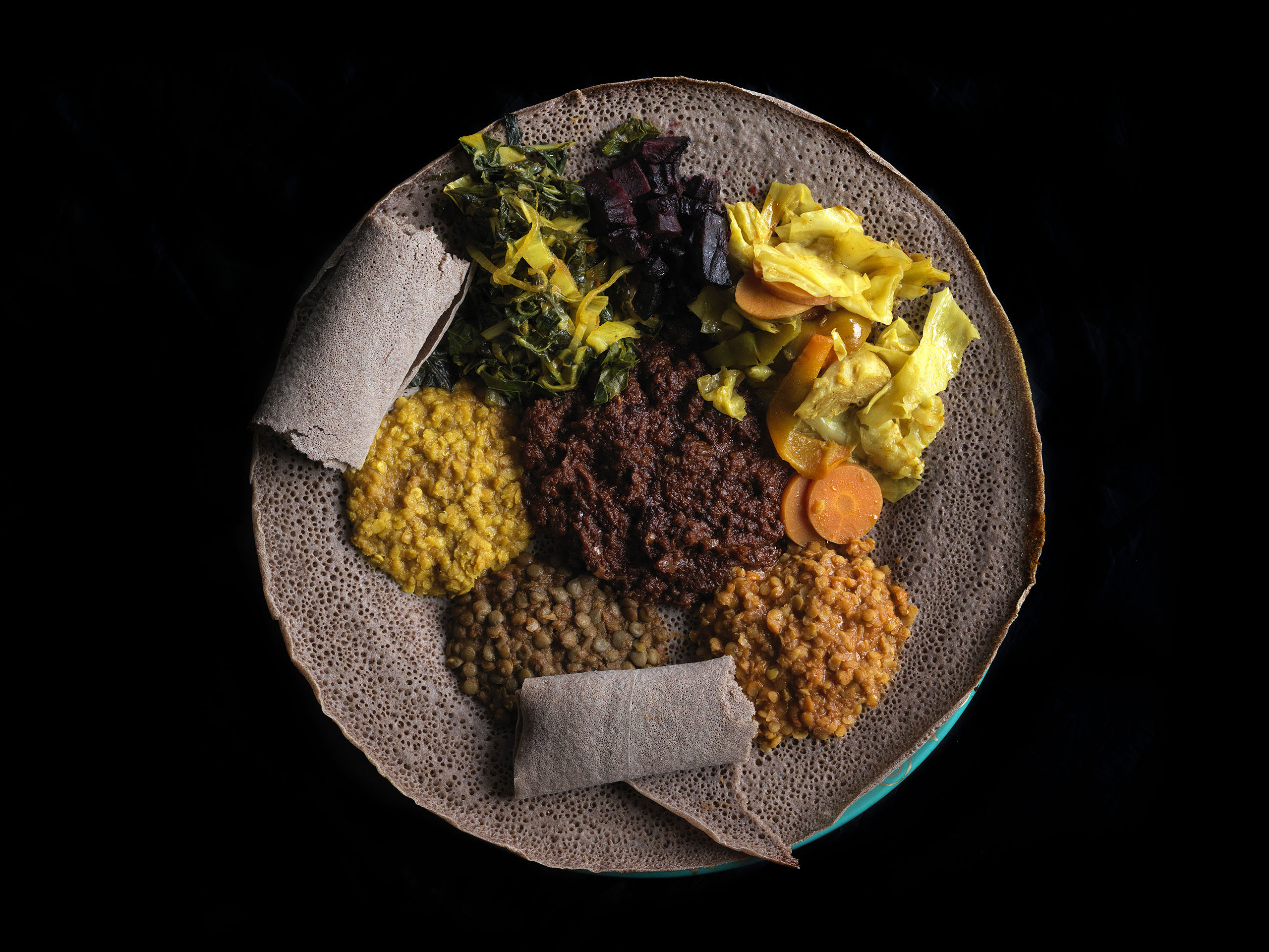 Ethiopian enjera - fermented crepe with pickles, ferments and lamb curry
